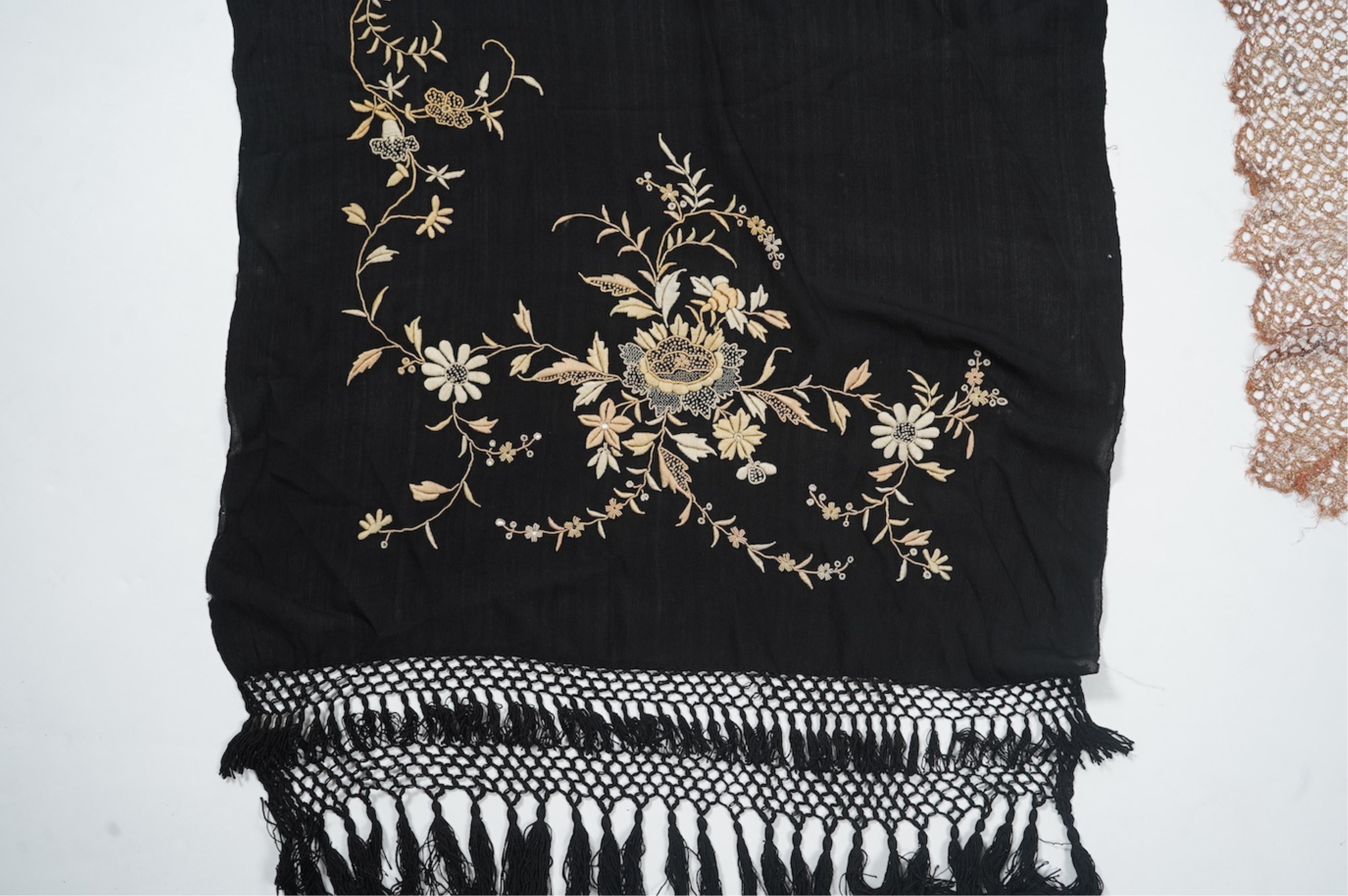 An Art Deco black silk floral embroidered shawl, using tones of red and orange with gold highlights, bordered with bronze metallic lace, together with a black crepe and yellow silk embroidered stole. Art Deco stole, 142c
